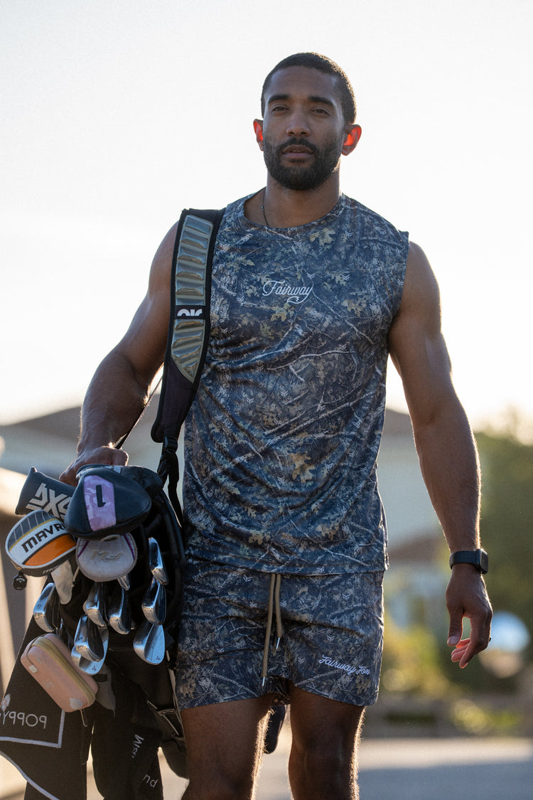 Golfer carrying clubs in Birdie Hunt camo