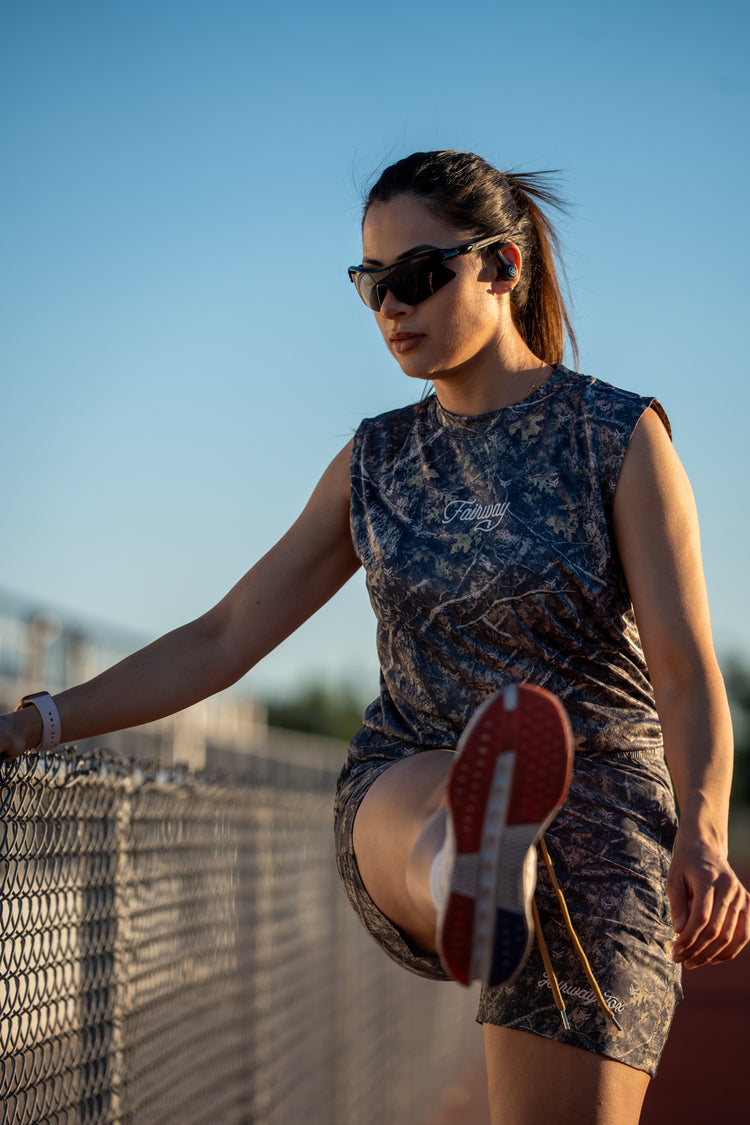 Golfer stretching trackside in the Birdie Hunt camo set